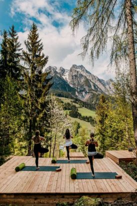 Open air Yoga in the forest at Design Hotel Forsthofgut & Spa, Leogang, Austria