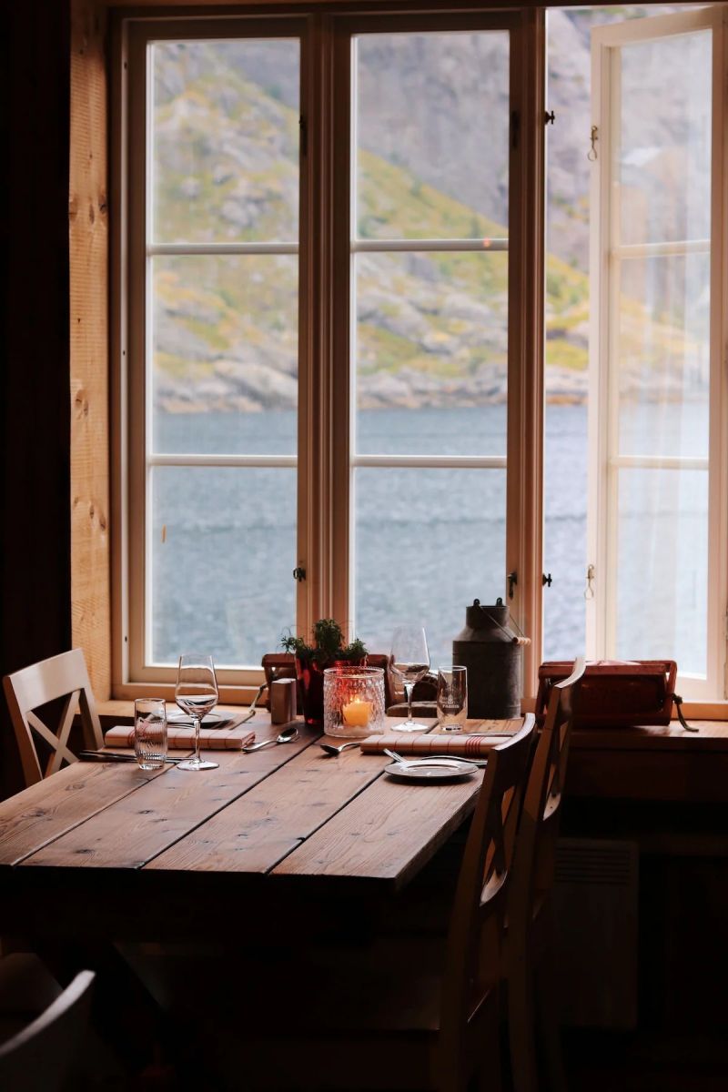 View to the Fjord through a historic window | NUSFJORD Lofoten Archipelago | Artic Luxury Hotels for Aurora Borealis/Northen Lights 