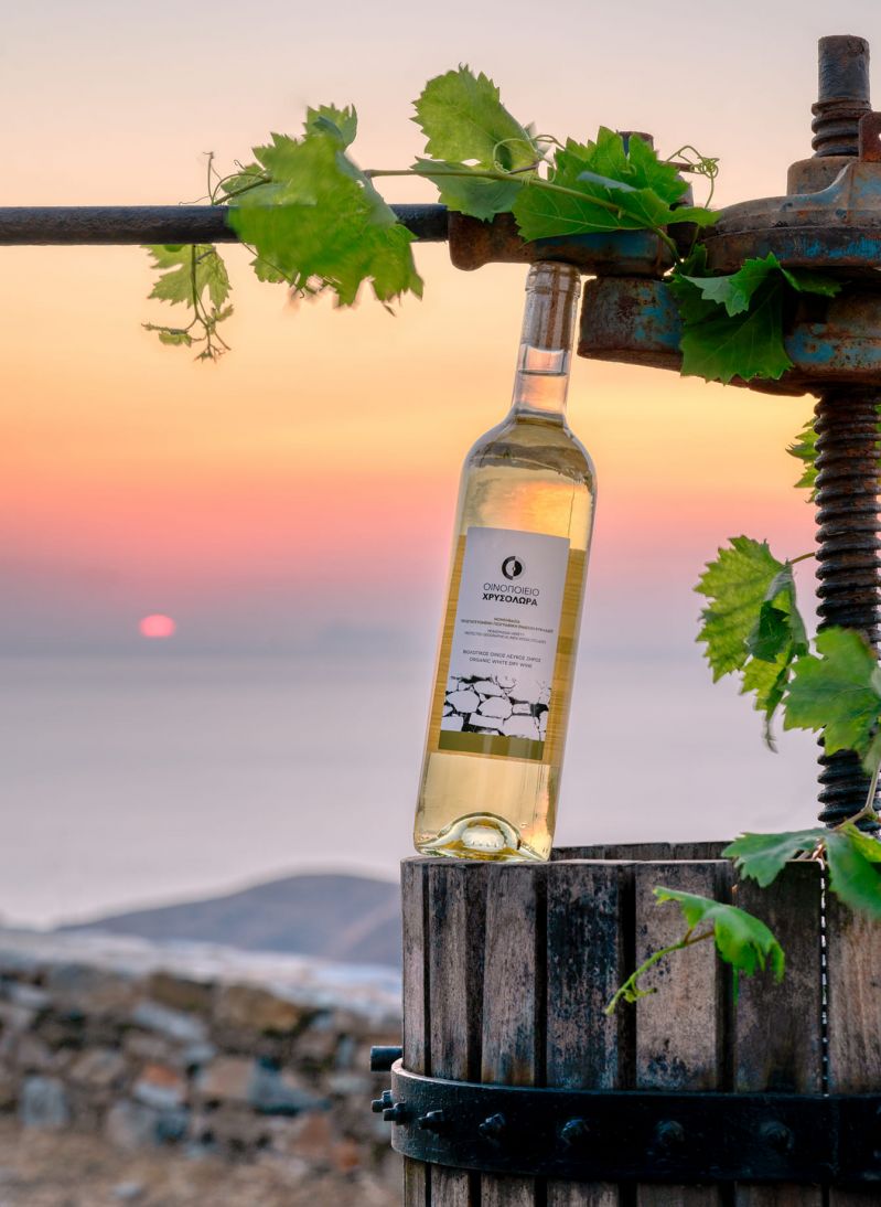 Wine Bottle, White wine set against sunset red skies with the Aegean in the distance on the island of Serifos | Natural wines on the Greek island of Serifos | Chrysoloras Winery