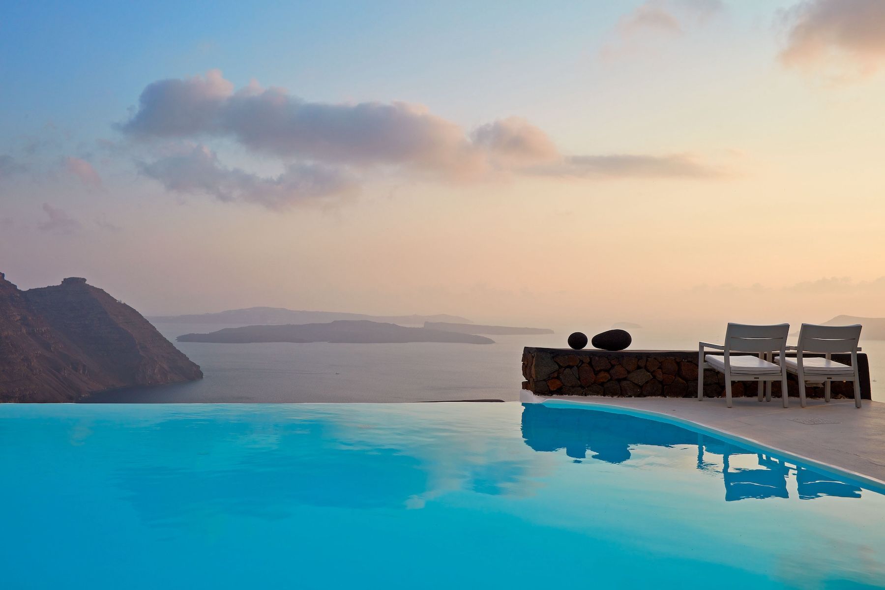 Cycladic archtitecture on Santorini, black on white, typical roof tops at Aenaon Villas Caldera 