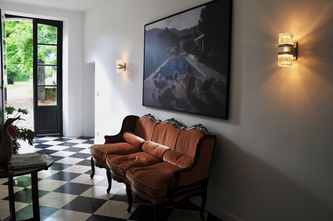  Interior living space vintage leather sofa checkered floor French doors boutique accommodation mid-century modern design | The Aficionados