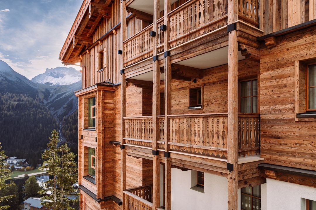 Traidtional Swisss Chalet facade New built- construction. Heritage architecture ont he Alps, timber window boxes, balcony, ornate carpentery | BelArosa Chalet – Luxury All-Suite Design Hotel & Alpine Escape in Arosa | The Aficionados 