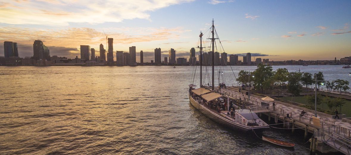 Sun set image form TriBeCa showing floating dining Grand Banks restuarant at pier 25 NYC