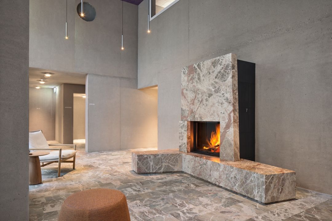 Beautifully deisgned Marble fireplace, statement piece in a minimalist style | Maistra 160 Pontresina, Engadin | The Best Design Hotels & Spas in Grisons, Switzerland | Designed by Architect Gion A. Caminada | Plattner & Plattner