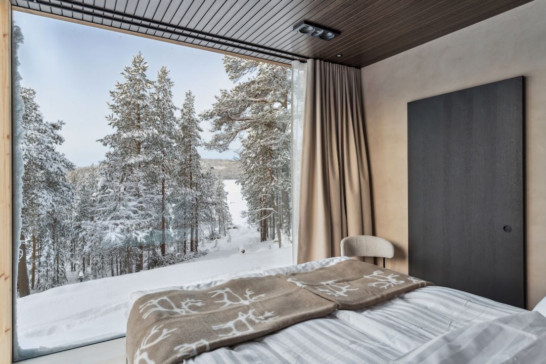 Contemporary bedroom with panoramic windows, natural materials and refined Nordic craftsmanship by Kati Anglé and Tapani Takkunen: Inai Haven Lapland: Luxury Private-Hire Contemporary Timber Villas on Lake Inari, Finland.