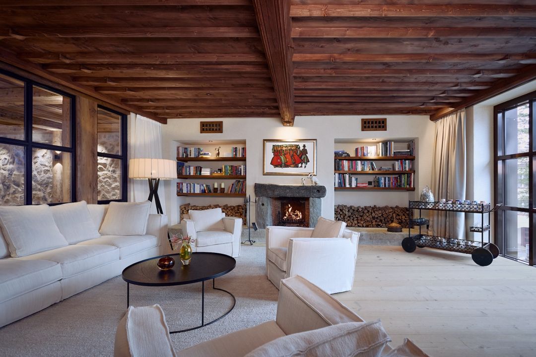 Contemporoary Alpine Styling with white sofa, timbers, stone and artworks | Modern Swiss Interior Desgin | BelArosa Chalet – Luxury All-Suite Design Hotel & Alpine Escape in Arosa | The Aficionados 