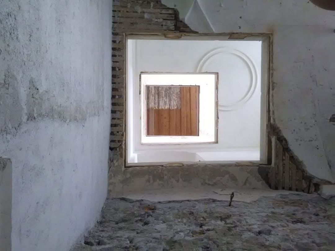 The glass panorama lift at the Kontor Boutiquehotel, cut through the historic ceiling construction of the house.