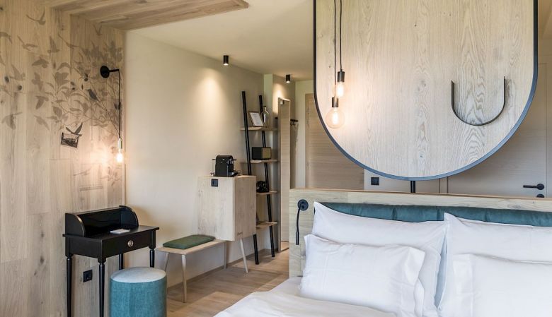 Gloriette Boutique Hotel Soprabolzano - Design Bedroom with arched windows designed by noa architects, overlooking the Dolomites in South Tyrol, Italy 