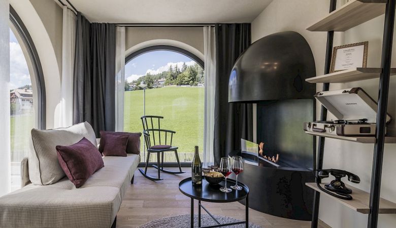 Gloriette Boutique Hotel Soprabolzano - Designer Suite Bedroom with arched windows designed by noa architects, overlooking the Dolomites in South Tyrol, Italy 