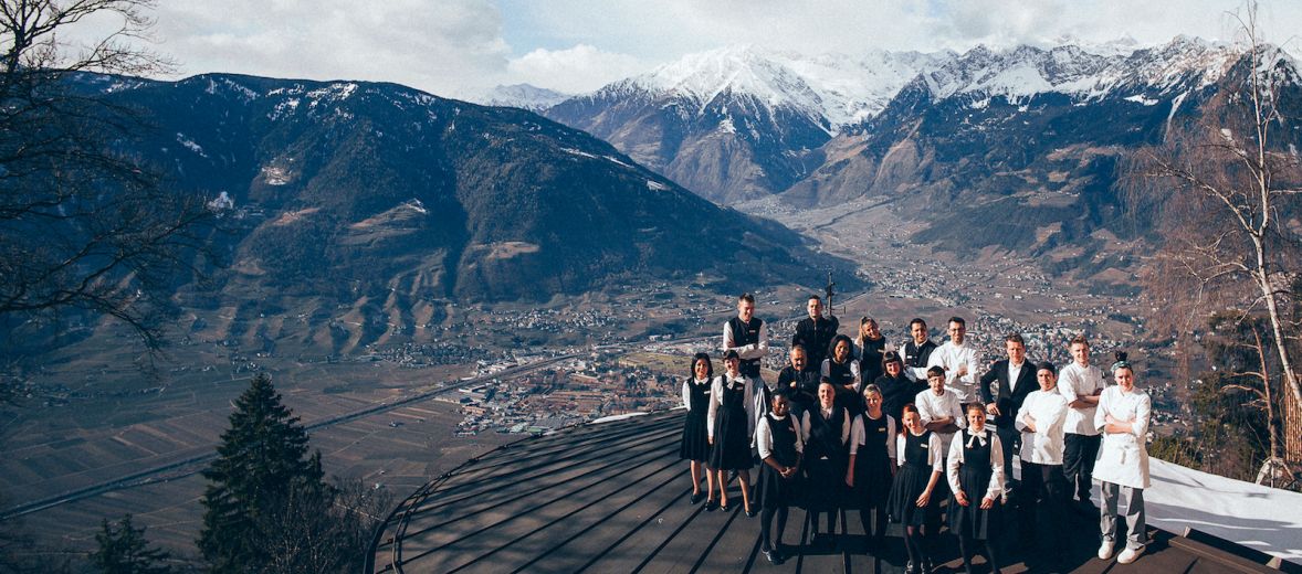 Fashion designer Sina Thomaseth with a crowd in her staff uniforms high overlooking a valley