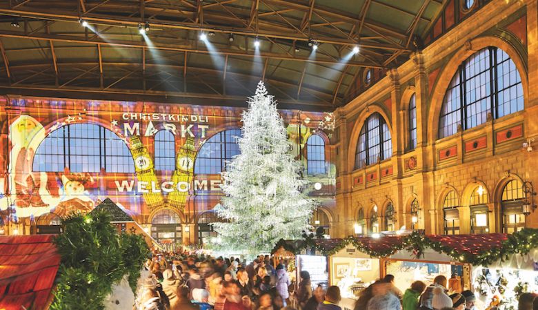 large indoor christmas market, huge christmas tree, swarovski crystals, stalls, presents, zurich, festive