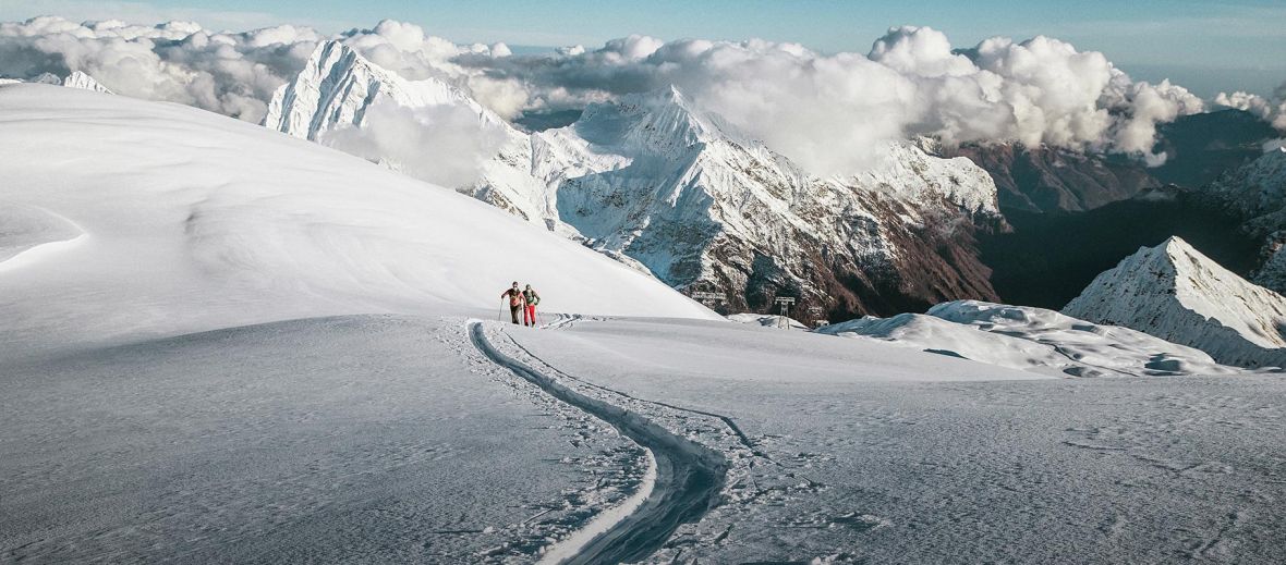 A ski trail leading through snow in the Alps