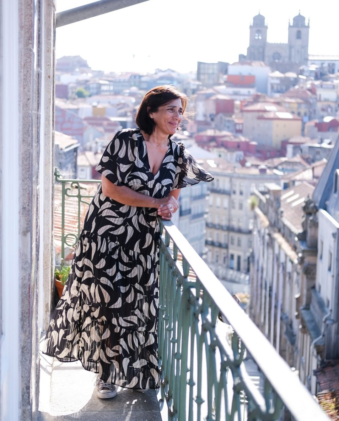 Alida Jamal, founder of B28 Apartments Porto, on a balcony of the restored 16th-century townhouse with the Sé Cathedral and Porto's old town in the distance | The Aficionados 