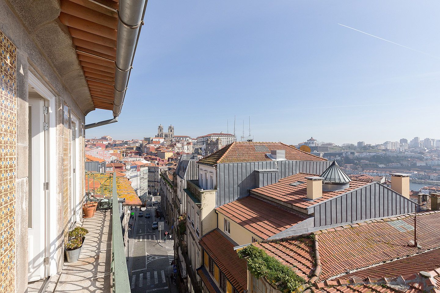 Porto's terracotta rooftops, the Sé Cathedral and the Douro river seen from a sage-green wrought-iron balcony at B28 Apartments in the old Jewish quarter.| The Aficionados 