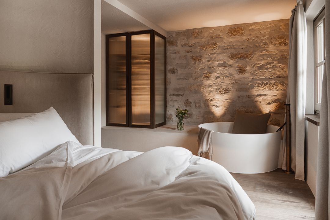Luxury Bedroom free standing bathtub and pastel interiors in modern Alpine style | Stieg’nhaus | Luxury Design Hotel in Austria’s Hochkönig | The Aficonados 