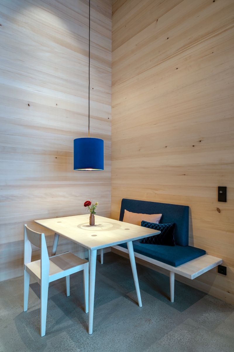 Minimalist Alpine Design Interiors table chair and wodden timber walls | Fuchsegg Eco Lodge, Bregenzerwald – Design Hotel in the Austrian Alps, Vorarlberg