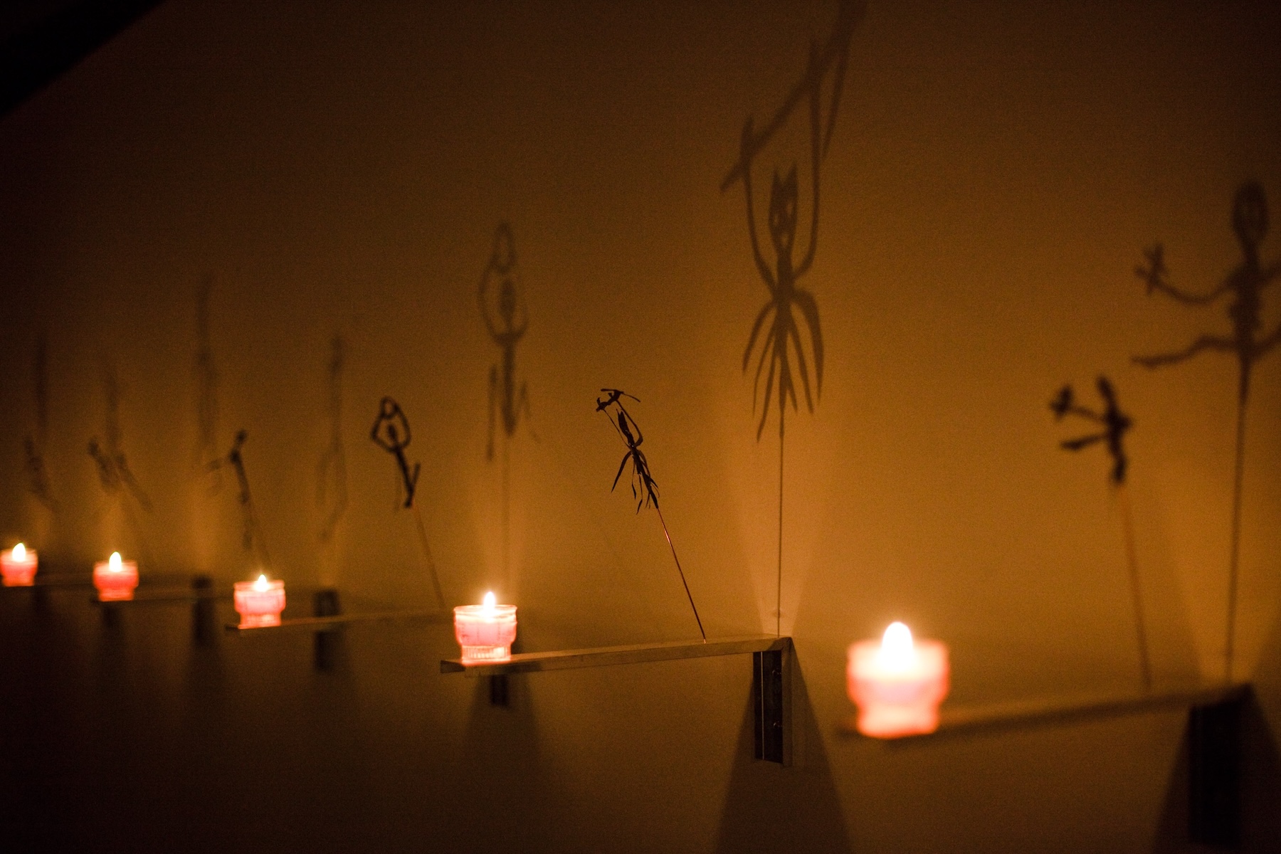 Candlelit shadow figures of Christian Boltanski's Vanitas in the cathedral crypt, Salzburg | The Aficionados