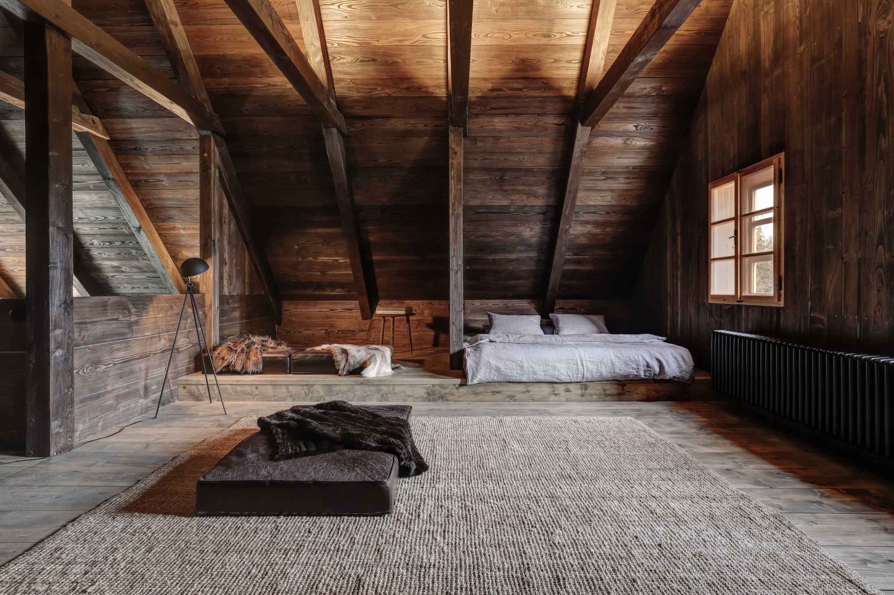 Beautifully desgined timber boutique hotel bedroom , pitched ceiling rafters oin honeyed woods - boutique Hotel design concept| Pantone's Mocha Mousse: Warmth of Design, Travel and Colour-led Hotel Style