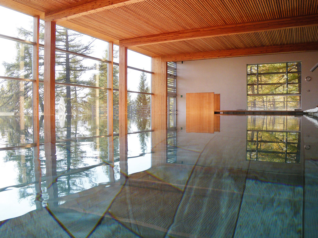 Swimming pool, indoor, natural light, full length glass panes of the forrest | Vigilius Mountain Resort South Tyrol |Stylish Travel to Italy: Boutique Hotels, Design Stays & Culture