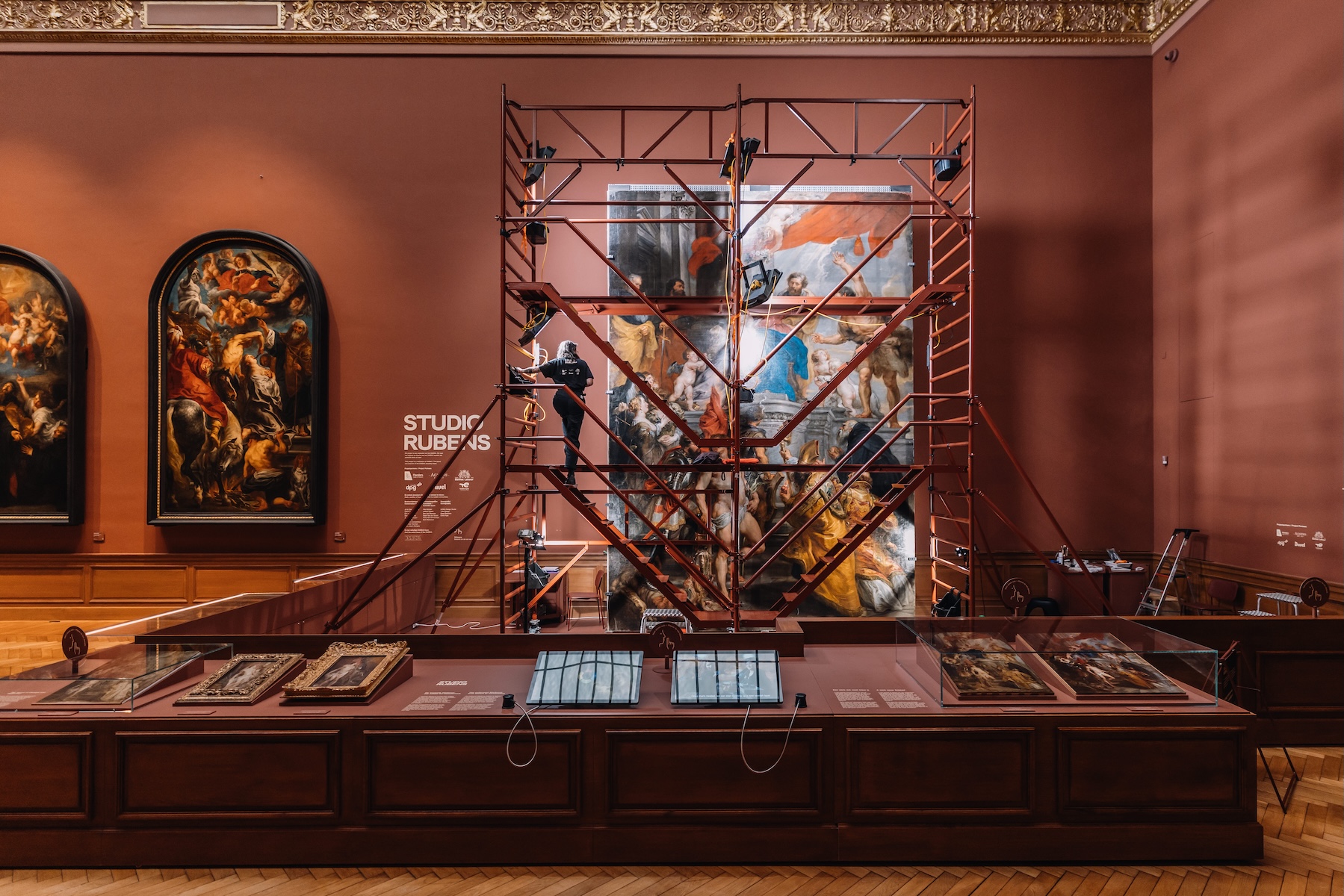 Conservator on scaffolding restoring a Rubens altarpiece in Studio Rubens at KMSKA, Antwerp | The Aficionados