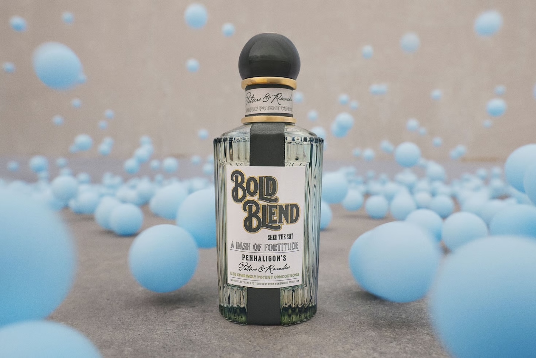 Penhaligon's Bold Blend eau de parfum bottle, ribbed glass with a dark domed stopper, against a backdrop of floating pale blue spheres