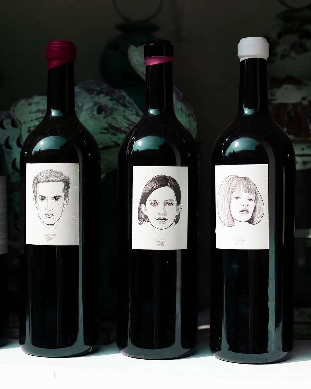 Oggau Wines distinctive wine bottle with faces|  hand drawn labels featuring various characters from Austria and Burgenland | The Vineyard Edit: Wine-Fuelled Boutique Hotels & Vineyard Stays