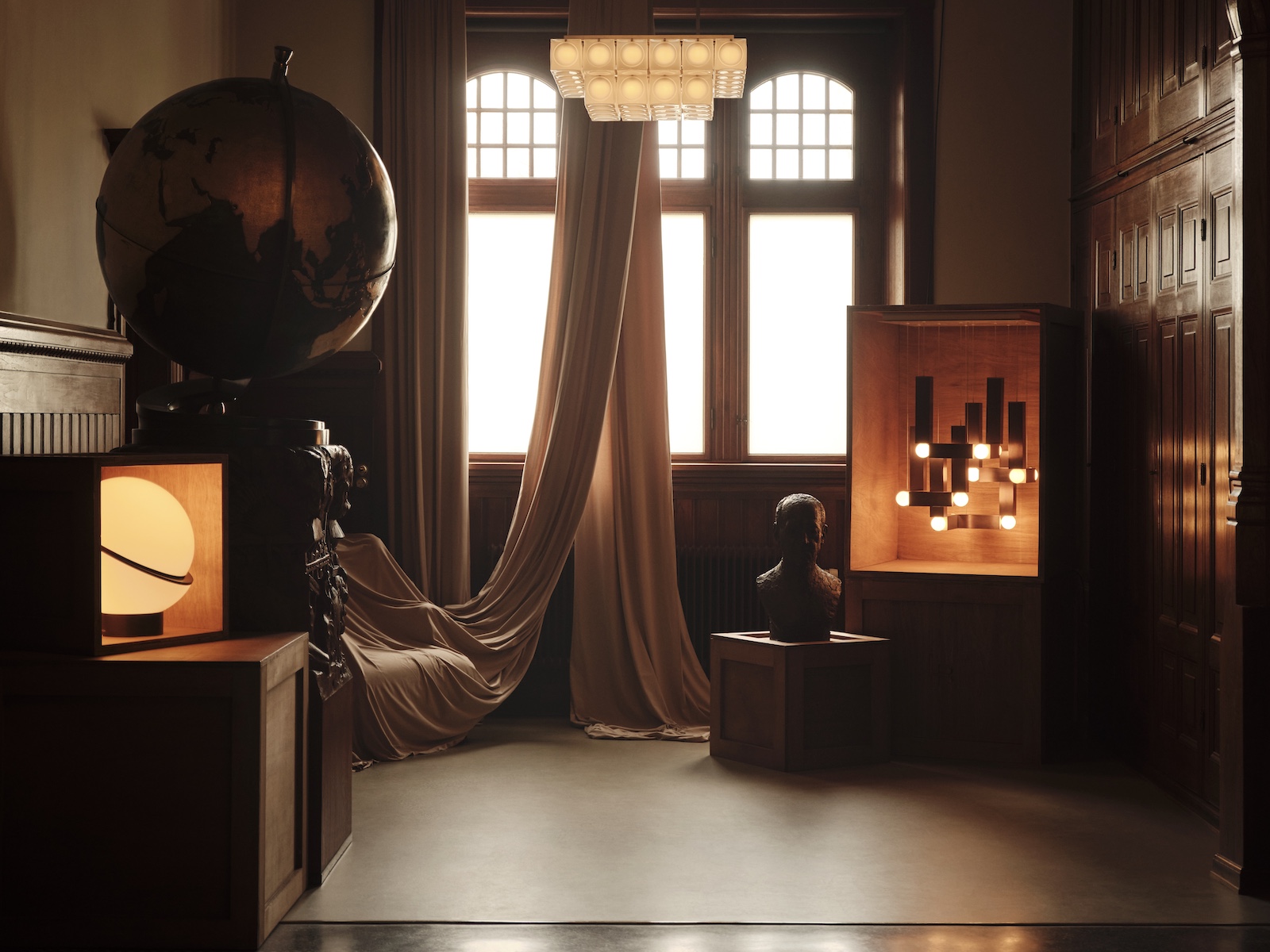 Dark timbers moody lighting, large antique globe | Lee Broom: British Lighting Designer Shaping Stories Through Illumination and Craft |The Aficionados 