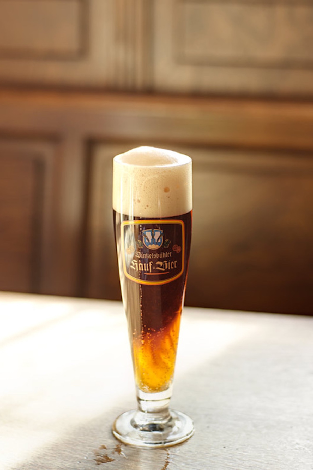 German Bavairan style Pils Beerr in glass with classic frothy top | Dinkelsbühl Bavaria: Design, Boutique Hotels and Travel Guide