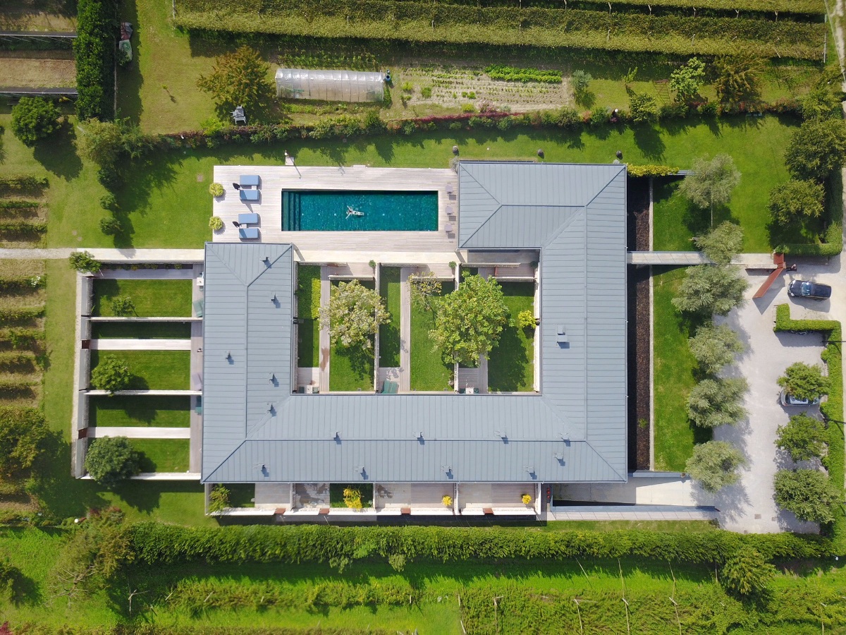 Birdseye veiw of Vivere Guesthouse Hotel in Arco, Lake Garda, Itlay - Zen type architecture formed in a square around a pool and vineyards |Stylish Travel to Italy: Boutique Hotels, Design Stays & Culture