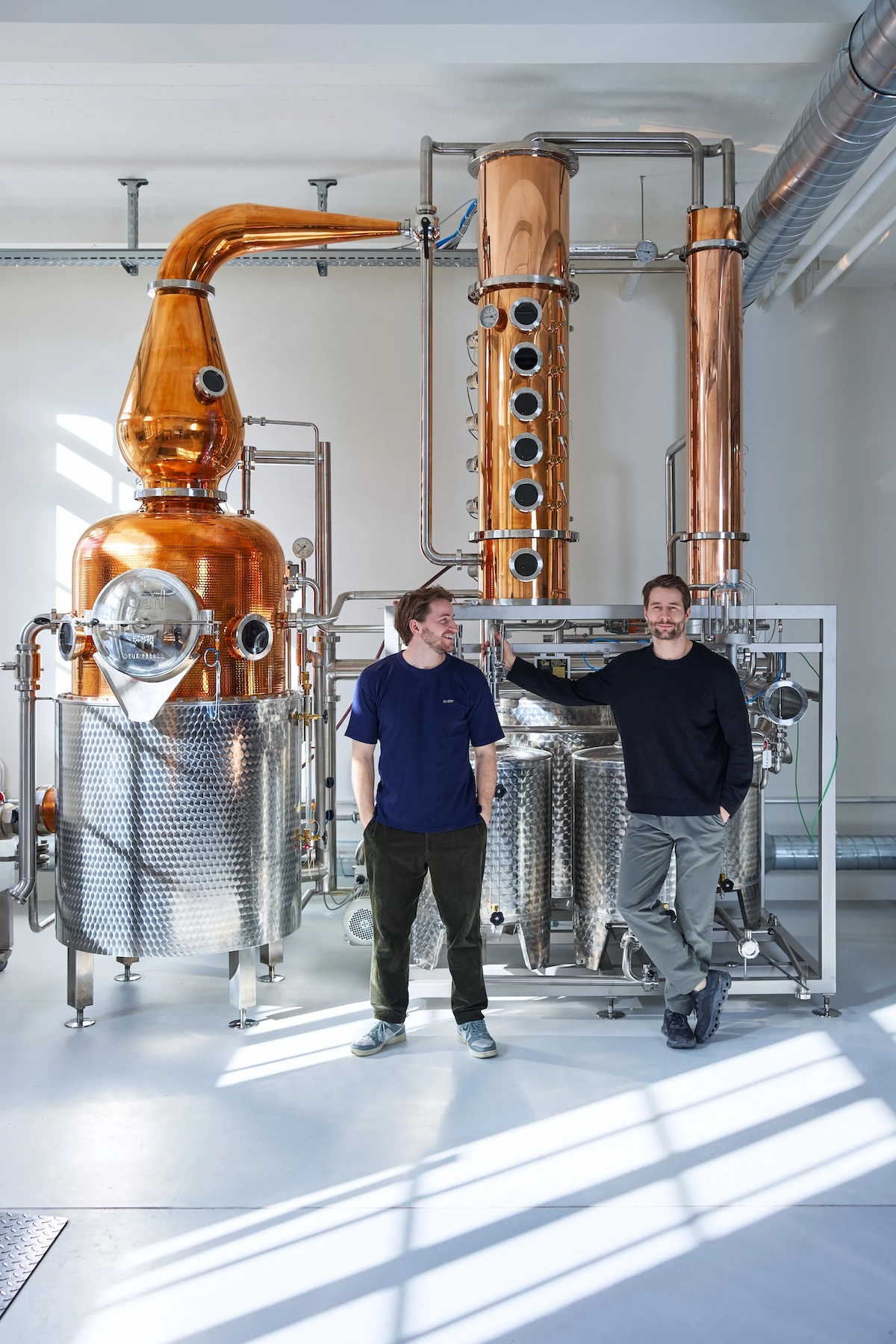 Two men standing in front of a Gin distilery at Deax Freres Zurich | Family Ties & Design Minds – Hotels, Style & Flavour Shaped by Kinship 