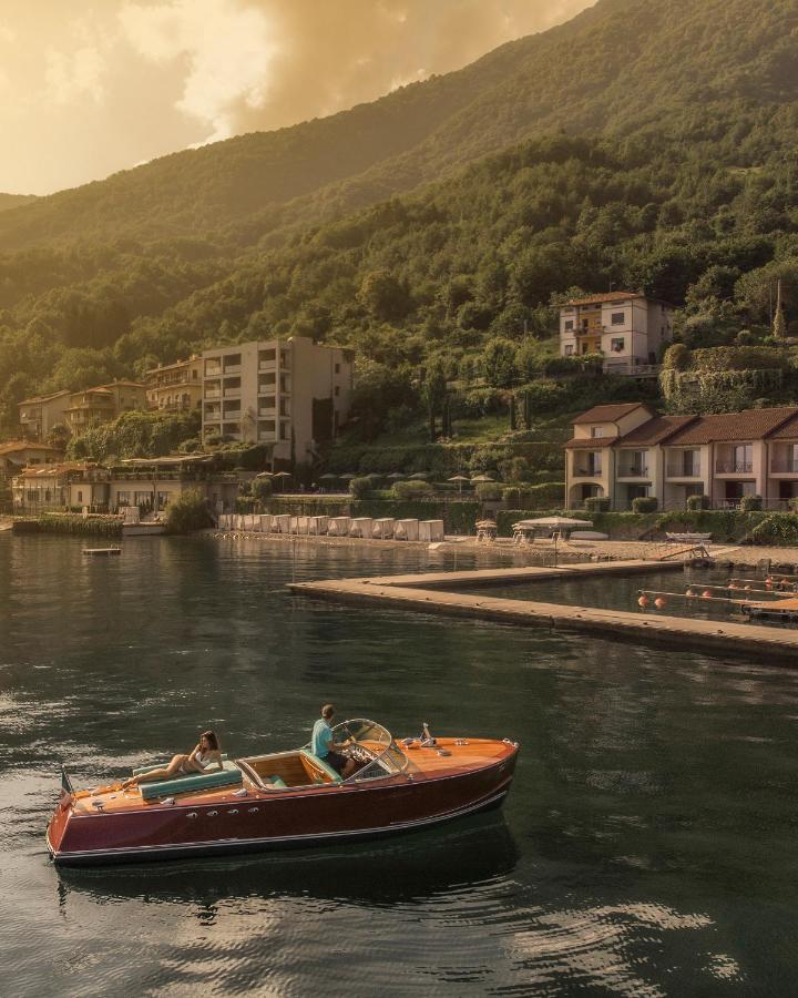Classic motor boat approaching the quayside dock of Filario Hotel & Residencies on Lake Como 