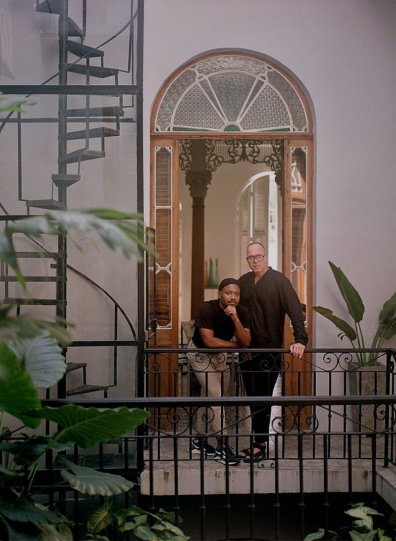 Sandy Solano and artist Andre sttod on the balcony of thier old style Havana Boutique hotel, Cuba | Manmade: 12 Hotels Shaped by Men of Design and Style