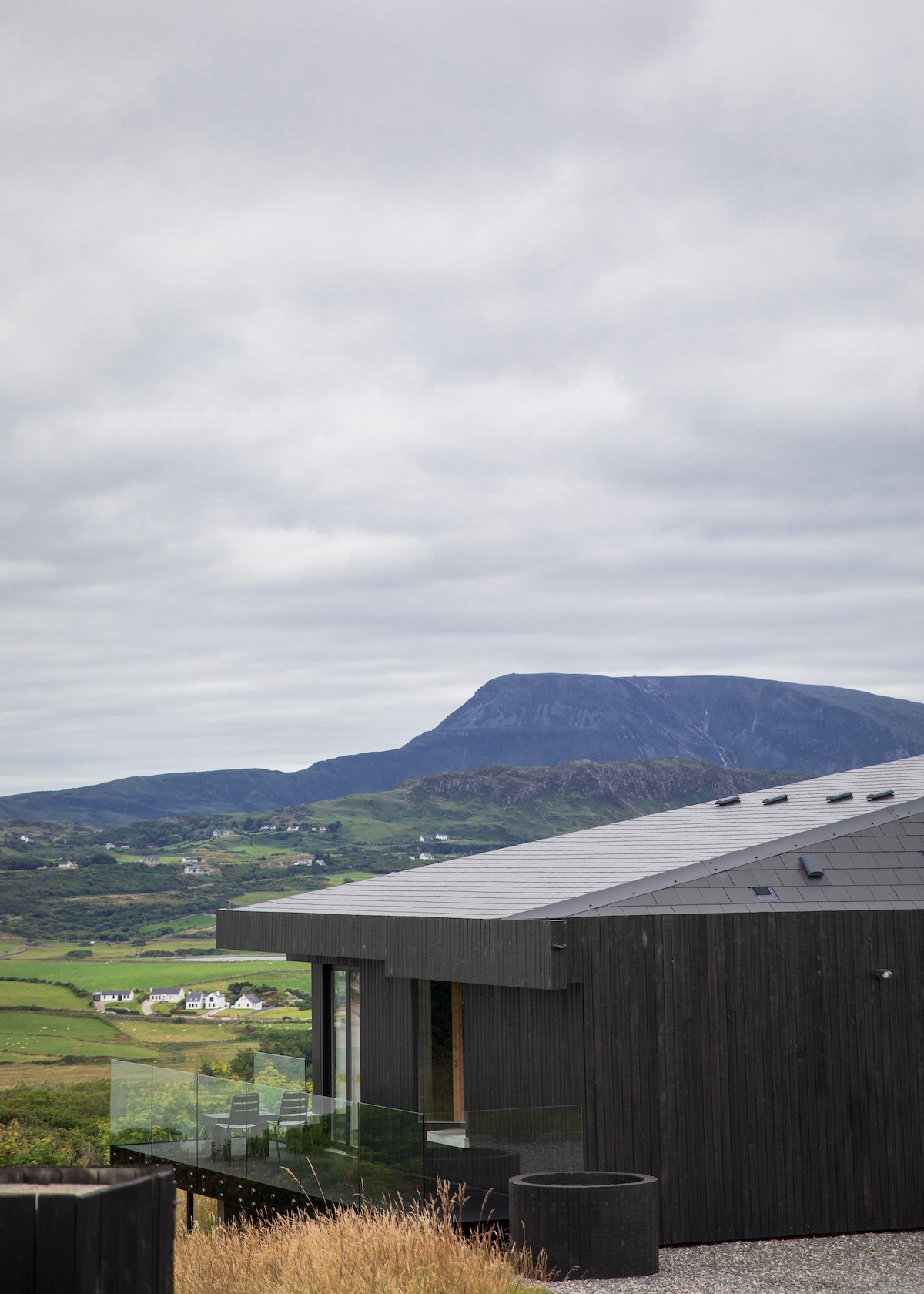 Breac House Ireland Design Hotel > blackened timber silouette against mountains 