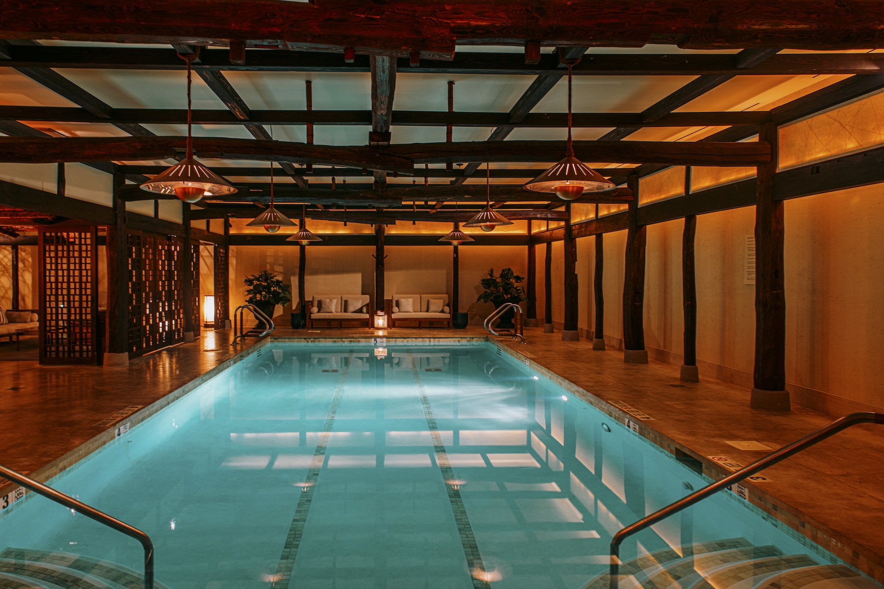 Illuminated pool in light blue set against traditional timber frame found in Japanese architecture | Shibui Spa NYC | Luxury Wellness Retreat at The Greenwich Hotel