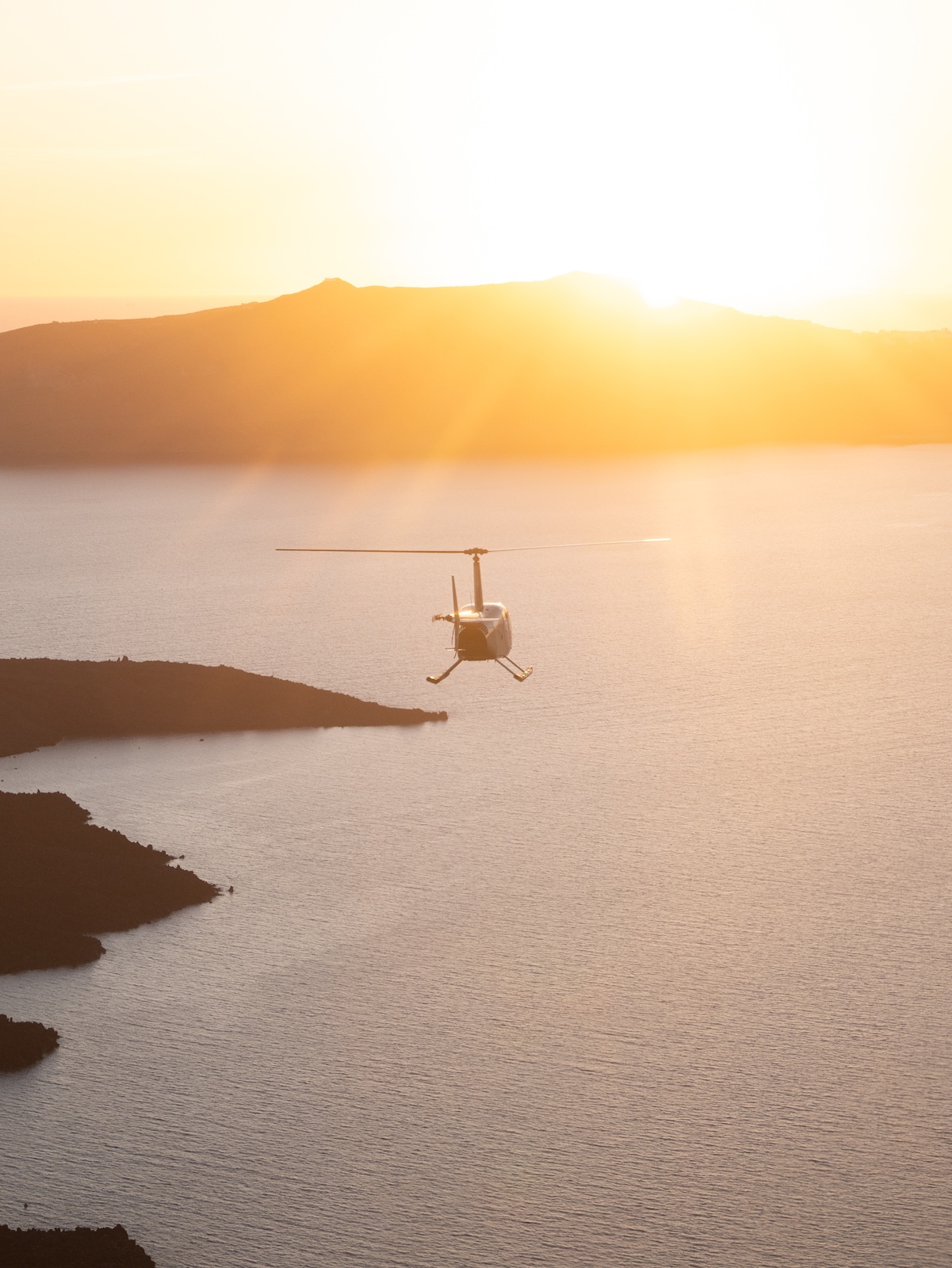 Sun set ove the Greek island from the air - altitude sunset image over the aegean shot from a helicopter | Greek Island Hopping by Helicopter: Fast-Track Culture & Design | HOPER Helicopter Airlines