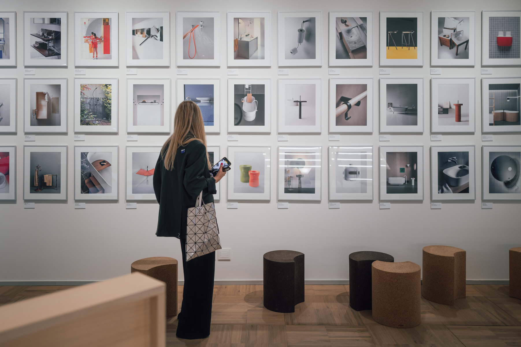 Woman standing in front of a gallery of photos | Bathrooms, Bath Tubs, Wash Bason |Agape: Sculptural Bathroom Design Across Iconic Hotels | The Aficionados 