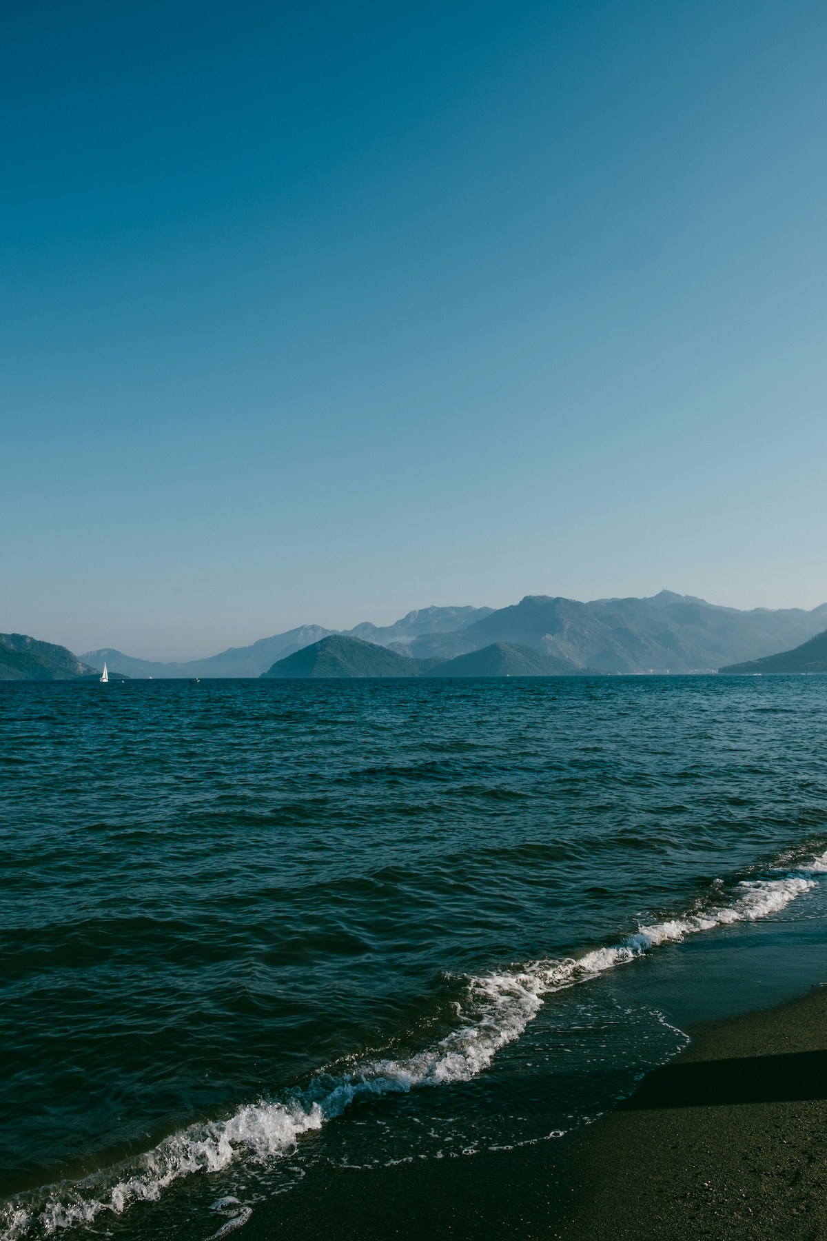 White crest of waves rolling on the beach | Mediterranean Aegean Sea bech | Untamed Beauty of Türkiye’s Riviera: A Journey Through Ancient Bays and Forested Shores