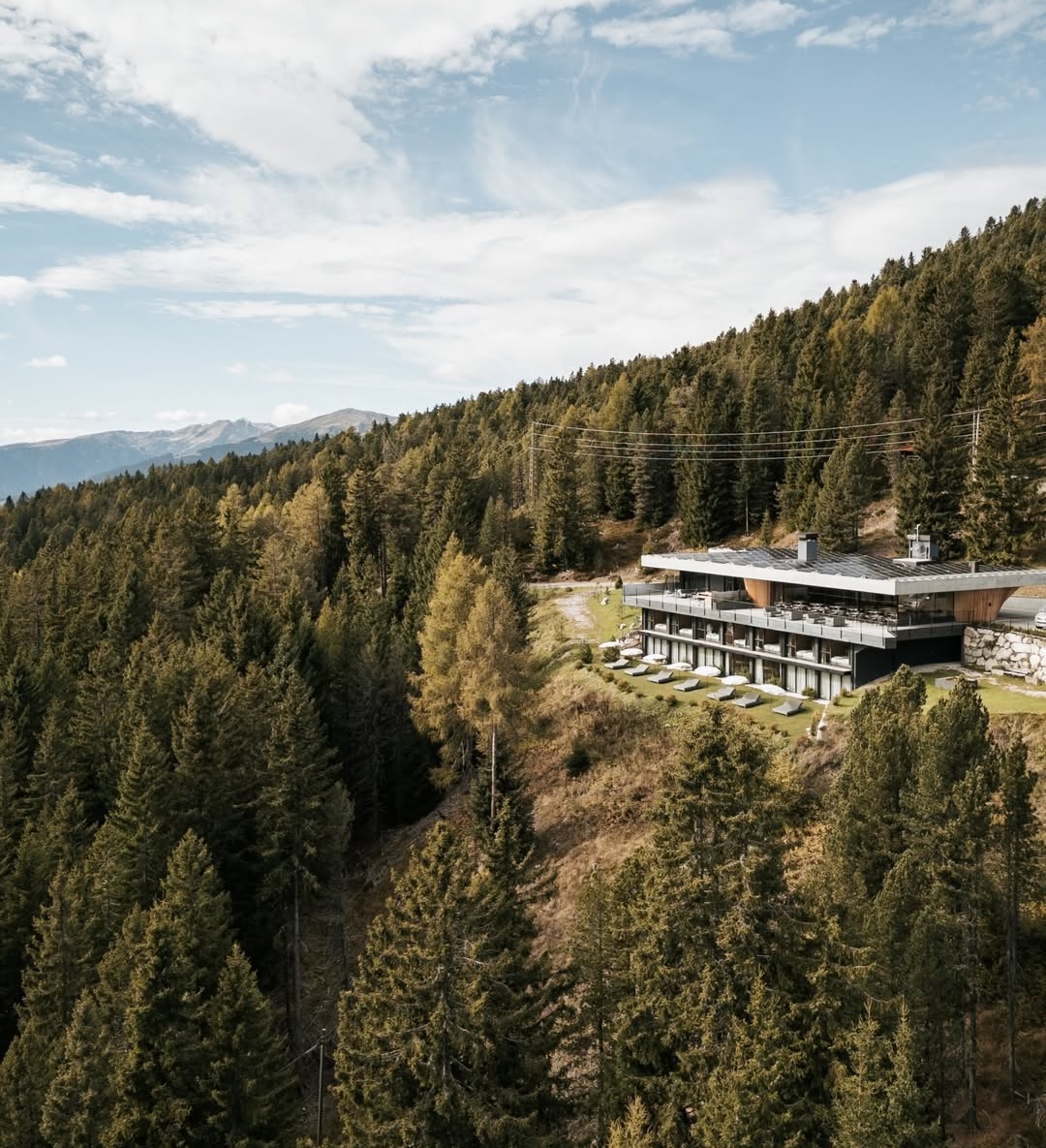 Long low suites building set into the forested slope of the Plose massif, architect Martin Gruber | Anders Mountain Suites, South Tyrol, Italy | The Aficionados