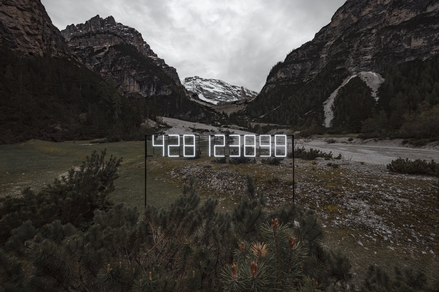 White Flourescent tubing into digital numbers - art installation in SMACH Biennale 2025: Contemporary Art in the Dolomites, Val Badia