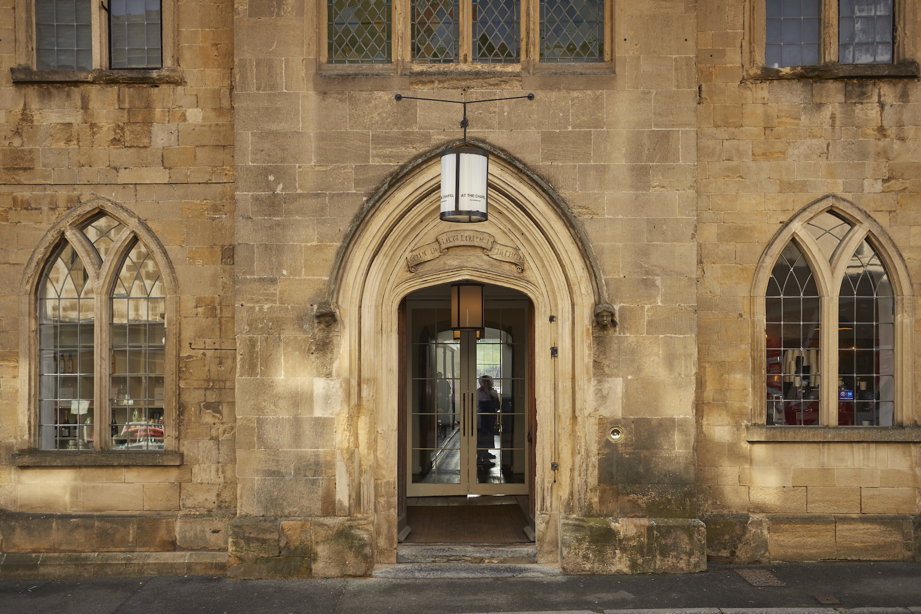 Historic Entrance Englsih Build Heritage CHapel Turned Boutique Hotel illuminated at night |At the Chapel, Bruton – Boutique Hotel, Dining & Design Retreat in Somerset | The Aficionados