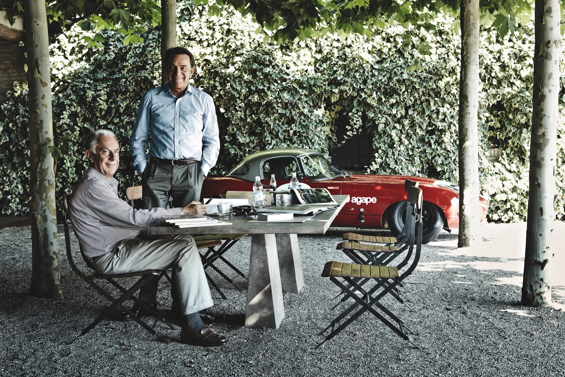 Founders of AGAPE Bathroom Desginers  Giampaolo + Emanuele sitting outside in front of a red classic car | Family Ties & Design Minds – Hotels, Style & Flavour Shaped by Kinship