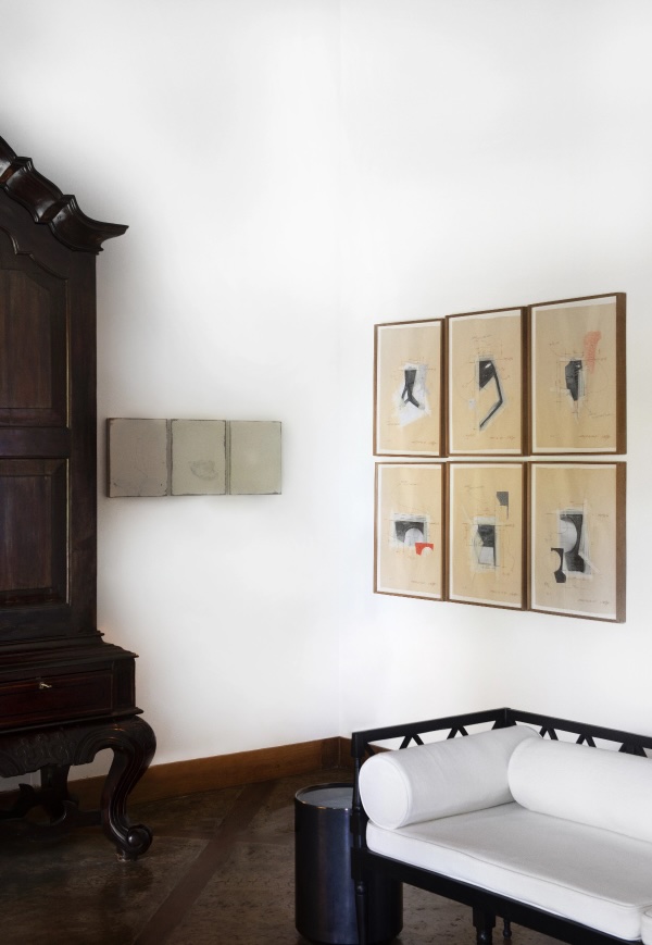 Antique Dutch colonial cabinet beside a six-panel grid of figurative works on paper and a small minimalist triptych, gallery-like living space at Doornberg, Peter Harris's restored villa above Galle, Sri Lanka | The Aficionados.