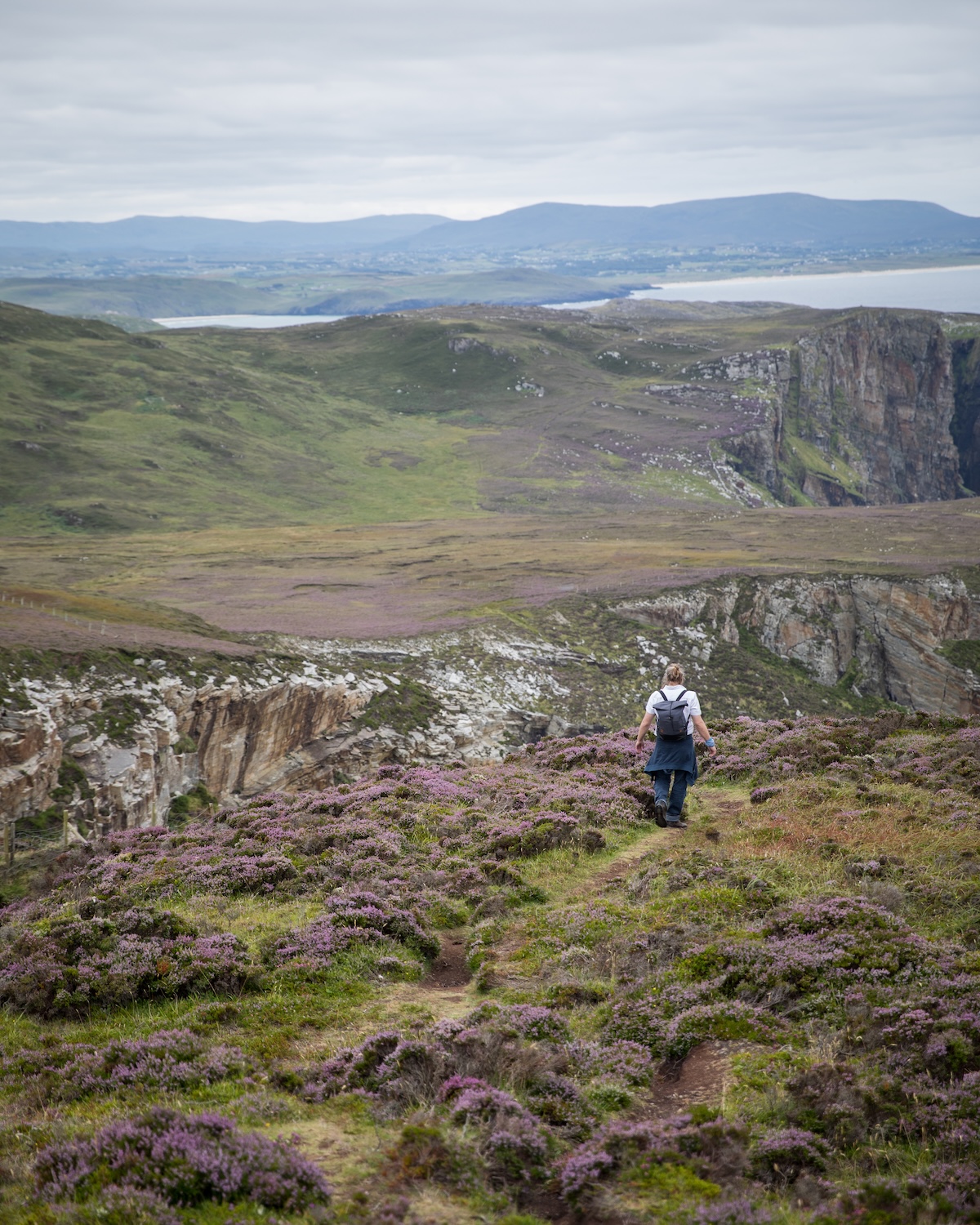 Wild coastal cliff meados - man walking , colour wild natiure of Ireland |The Far Edge of Ireland Experience at Breac.House, Donegal | Limited April Design Retreat