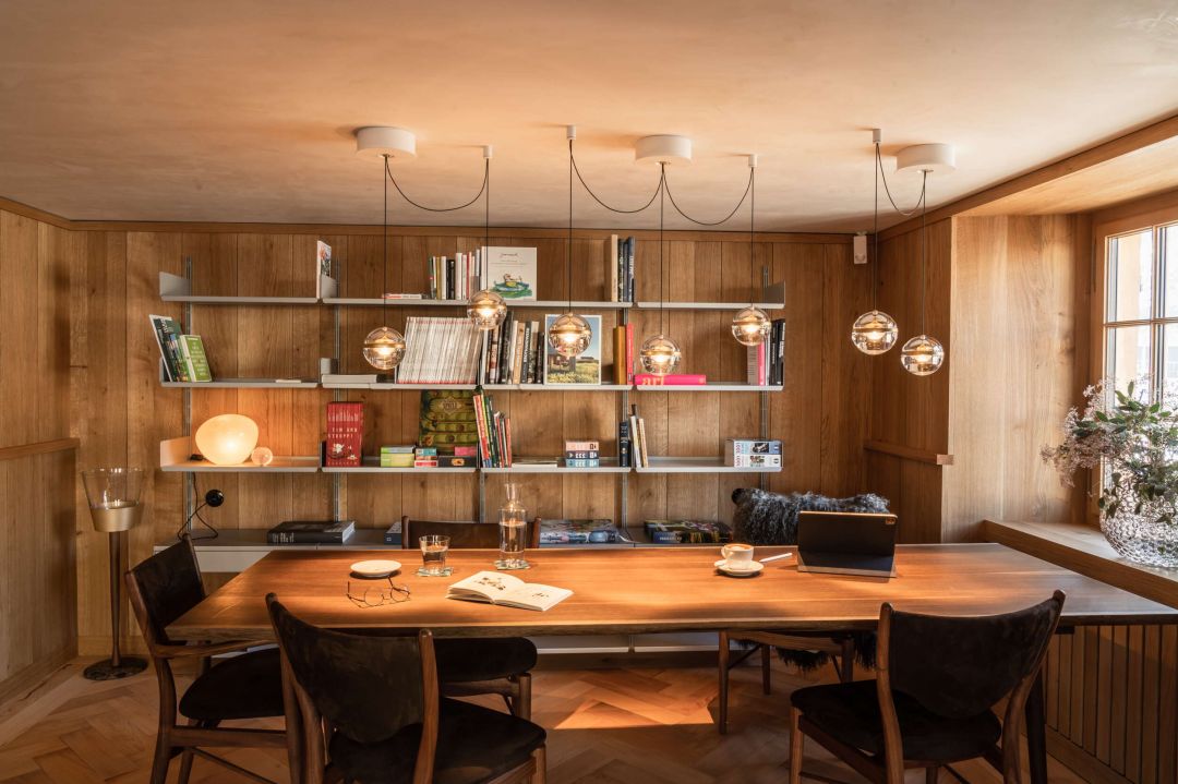 Contemporary boardroom meeeting space featuring designer lighting, book shelves at Traube Hotel in Buchs Switzerland | The Art of Desking: Stylish Hotels for Work, Rest & Play – The Aficionados