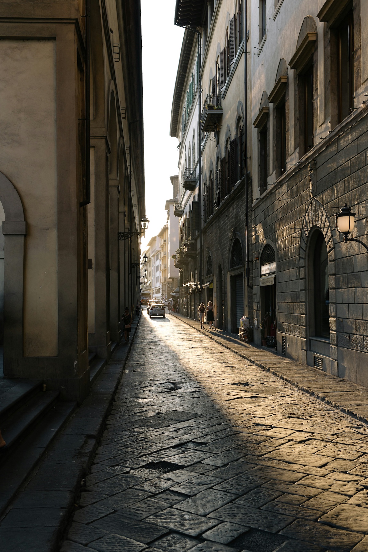 Black and white street view in Florence with the sun casting a magical shadow along the road |Florence | Firenze – Where Marble Saints Meet Leather Rebels