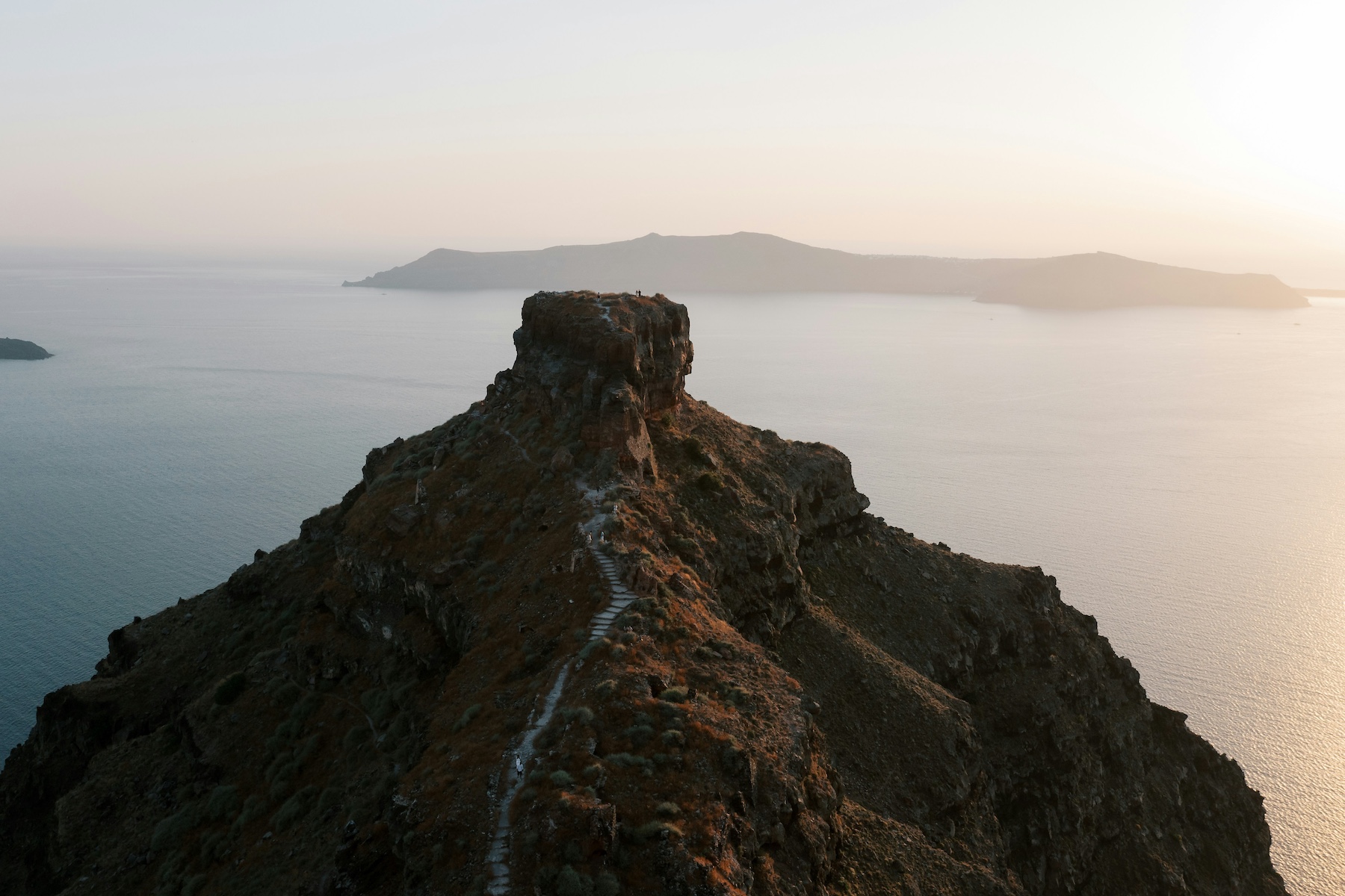 Aegean Sea blue against the black cliffs |Santorini Noir: Volcanic Beauty, Architecture and Cycladic Soul | The Cyclades Island of Greece | The Aficionados 