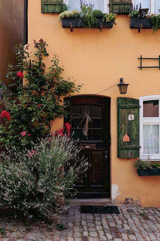 Outside on eof the many breweries found in the anicent town, inviting ornage coloured walls of the tavern and biergarten  | Dinkelsbühl Bavaria: Design, Boutique Hotels and Travel Guide
