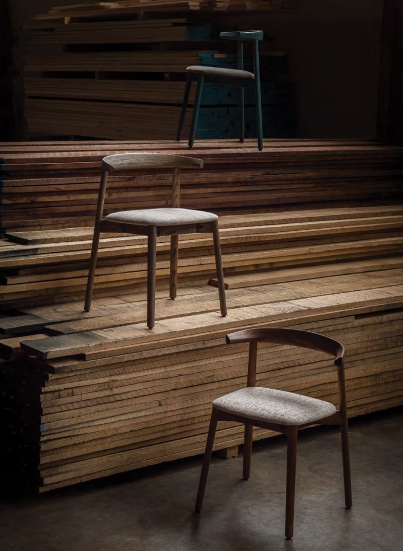 Three De La Espada chairs set among stacks of air-drying timber at the Mira workshop | The Aficionados