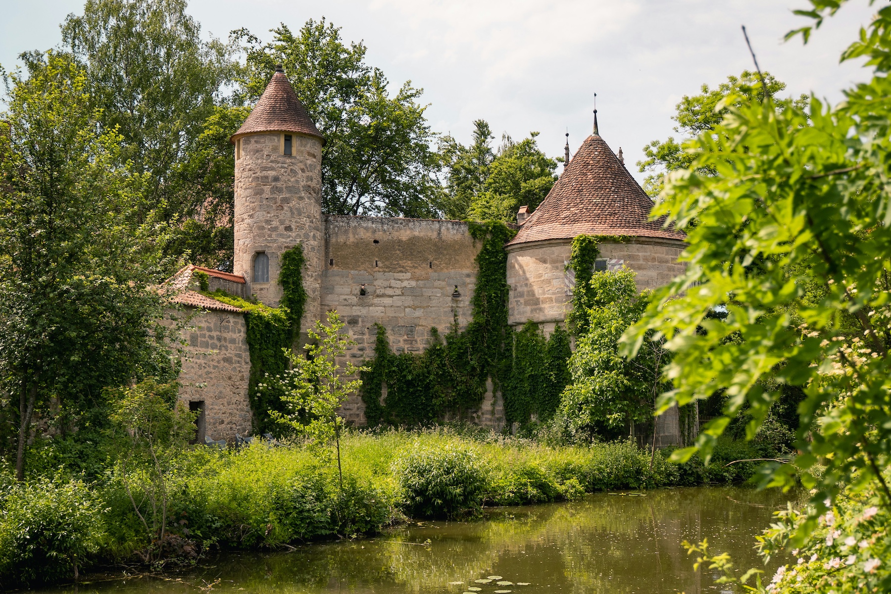 Old Historic German style Castle wrapped by mature green trees | Dinkelsbühl Bavaria: Design, Boutique Hotels and Travel Guide