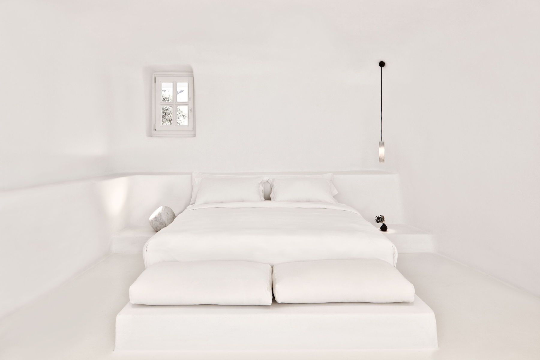 Cycladic archtitecture on Santorini, black on white, typical roof tops at Aenaon Villas Caldera 